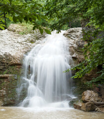 Fototapeta premium Beautiful waterfall in a dense forest
