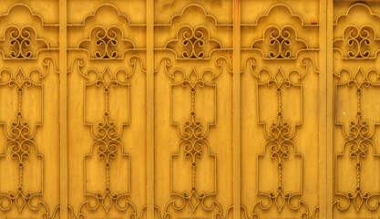 Yellow floral pattern on metallic wall. It constructed with metal.