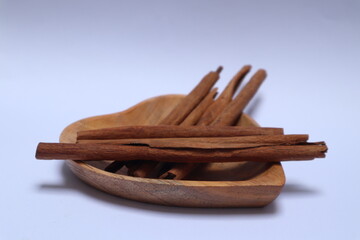 stacks of cinnamons in a heart shaped wooden bowl