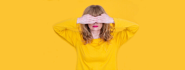 woman covering her eyes with her hands in denial