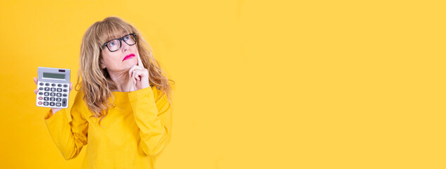 woman thinking with calculator in hand isolated