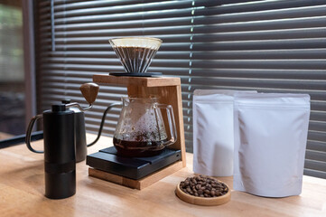 Hand drip coffee, Barista making drip coffee with mockup blank package coffee Alternative ways of brewing Coffee shop concept