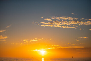 Seascape golden sunrise over the sea. Nature landscape. Beautiful orange and yellow color on ocean sunset. Seascape with gold sky and clouds.
