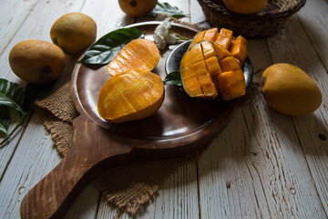 Sliced mango on wooden board with use of selective focus 
