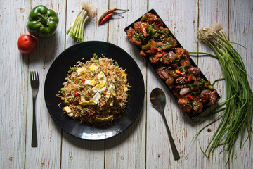 View from top of Chinese cuisine fried rice and dry chilli chicken. A popular dish across the globe.