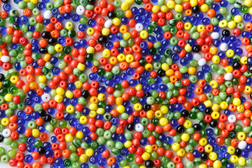Fototapeta na wymiar background of many small, colorful glass beads,