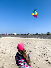 A person flying a kite on the beach.
