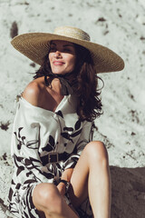 Young woman in summer hat on the beach