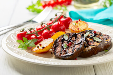 Grilled eggplant steaks with vegetables.