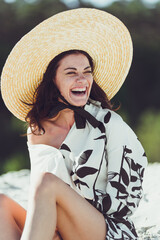 Young woman in summer hat on the beach