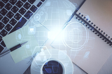 Social network hologram drawings over computer on the desktop background. Top view. Double exposure.
