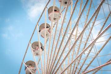 Detail of ferris wheel cars against a blue summer sky