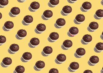 Seamless pattern chocolate cup cake on yellow background.