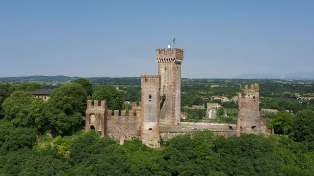 Castle Scaligero in Valeggio sul Mincio, Verona, Italy. Aerial view of the Italian historic castle Castello Scaligero on a hill, view of the Ponte Visconteo bridge and the Mincio river.