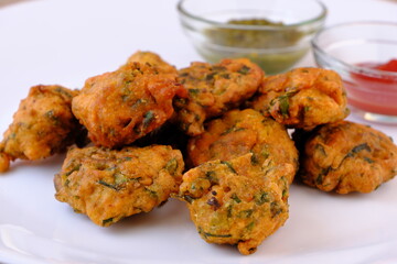 Indian snack pakora with tomato sauce or chutney