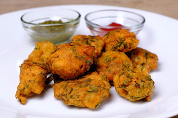 Indian snack pakora with tomato sauce or chutney