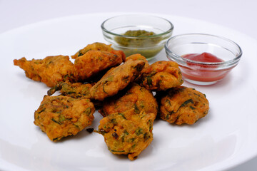 Indian snack pakora with tomato sauce or chutney