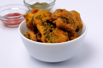 Indian snack pakora with tomato sauce or chutney