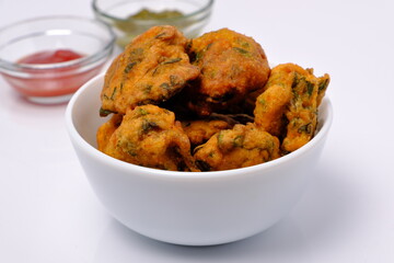Indian snack pakora with tomato sauce or chutney