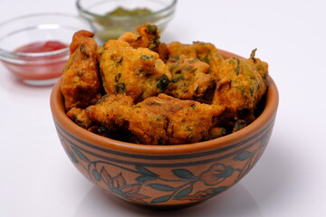 Indian snack pakora with tomato sauce or chutney
