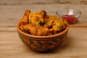 Indian snack pakora with tomato sauce or chutney