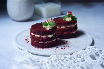 red velvet cake with cream cheese frosting on the table
