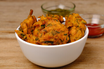Indian snack pakora with tomato sauce or chutney