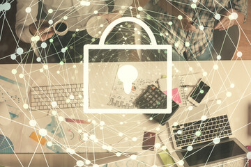 Double exposure of man and woman working together and lock hologram drawing. Security concept. Computer background. Top View.
