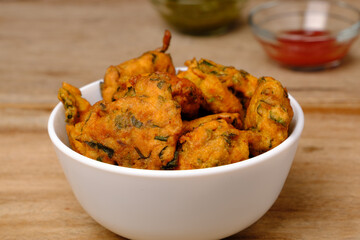 Indian snack pakora with tomato sauce or chutney
