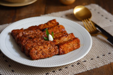 a plate of tempeh and tofu cooked in sweet soy sauce 