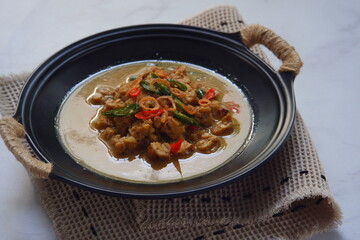 a bowl of tempeh cooked in coconut milk and spices named jangan ndeso in Bahasa
