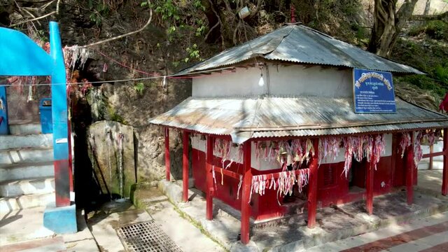 traditional Nepali temple where water coming from rock 