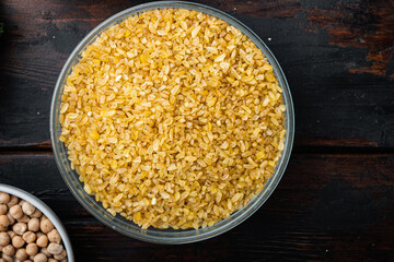 Bulgur grain, flat lay on dark wooden background