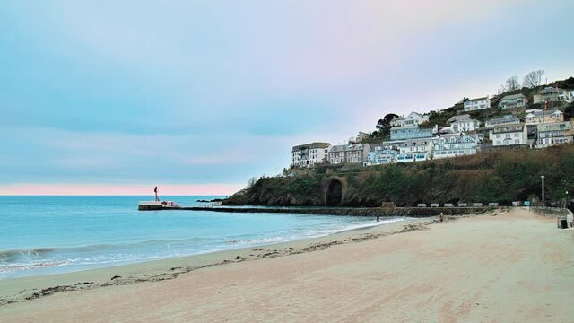 Looe Beach - South East Cornwall in 4K. Looe - coastal town and civil parish in England with multiple old English houses on the cliff and seashore of Looe Bay in the English Channel.