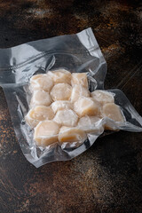 Scallops in vacuum pack, on old rustic background
