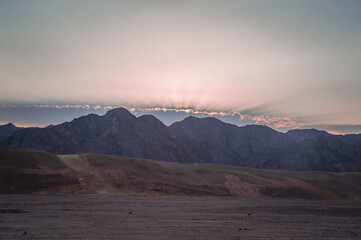 sunset behind striped amazing mountains desert of Sinai Peninsula