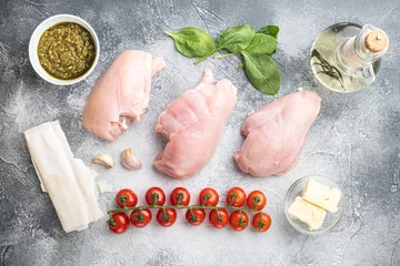 Tuinposter Chicken breast stuffed with ingredients and filo, on gray background, top view flat lay © Ilia Nesolenyi