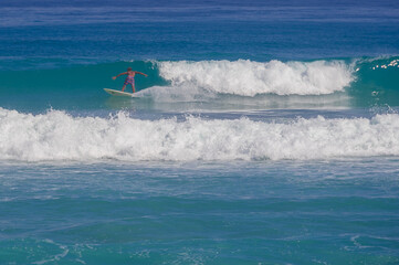 surfers catch high powerful waves of the Atlantic Ocean on the islands of the Caribbean