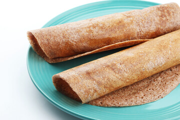 Ragi Dosa, finger millet Dosa, pan cake of finger millet flour healthy home made breakfast dish Karnataka, India. with chutney, Sambar