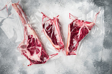 Raw uncooked beef steaks in vacuum packed air sealed sous vide bag, tomahawk, t bone and club steak...