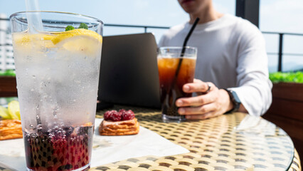 person holding glass of coffee in the cafe