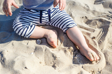 baby's legs on the beach