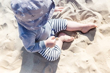 baby's legs on the beach