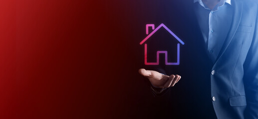 Real estate concept, businessman holding a house icon.House on Hand.Property insurance and security...