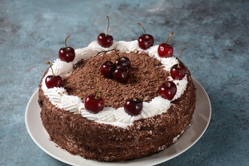Black forest cake, Schwarzwald pie, dark chocolate and cherry dessert . Black forest cake decorated with whipped cream and cherries.