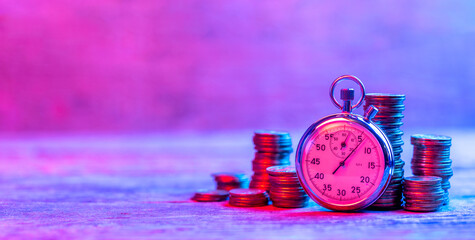 Fast money or Money is time. Stopwatch and stacks of money coins in neon light. Template Copy space for text