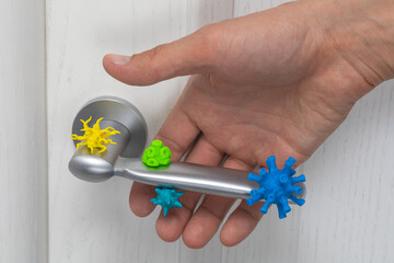 Virus-infected doorknob. The man takes the handle with viruses and germs. - obrazy, fototapety, plakaty