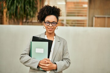 Fototapeta premium Young african american businesswoman smiling happy standing at the city.