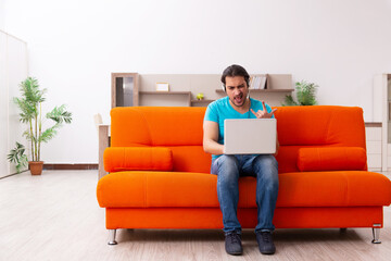 Young male student in tele-studying concept during pandemic