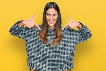 Young beautiful woman wearing casual clothes looking confident with smile on face, pointing oneself...